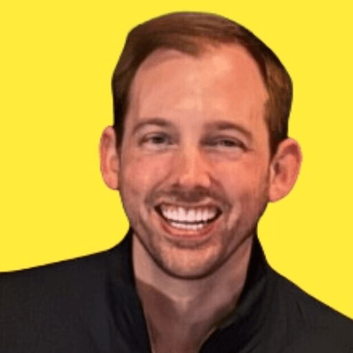 Ryan Durkin smiling against a yellow background